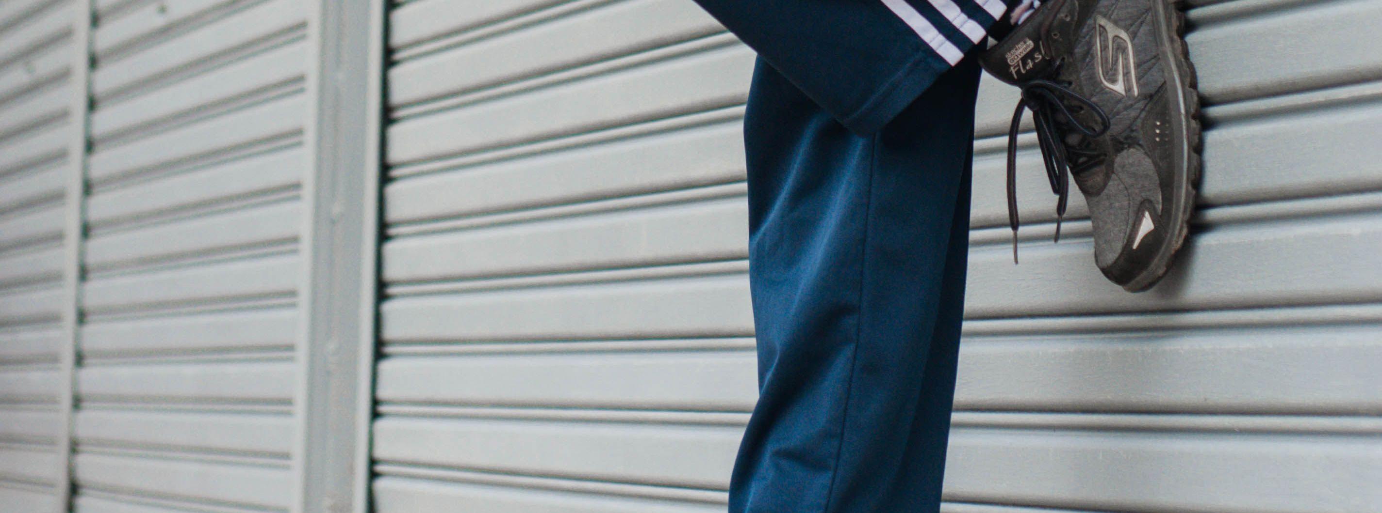 Person wearing Skechers GOwalk Flash trainers, mid-stride on an urban street